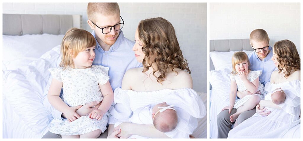 Family cuddles on the bed in Kathleen Jablonski's light and airy studio while they welcome newborn baby.